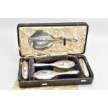 A SIX PIECE SILVER VANITY TRAVEL SET, comprising of a circular mirror, hair brush and clothes