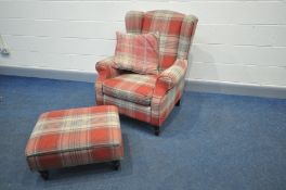 A NEXT UPHOLSTERED WINGED ARMCHAIR with matching footstool both with a red/beige tartan upholstery
