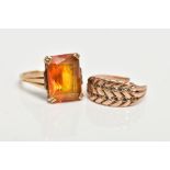 TWO YELLOW METAL RINGS, the first designed with a four claw set, rectangular cut citrine, textured