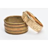 A ROLLED GOLD BANGLE AND ONE OTHER, the rolled gold bangle with a floral design to one side,