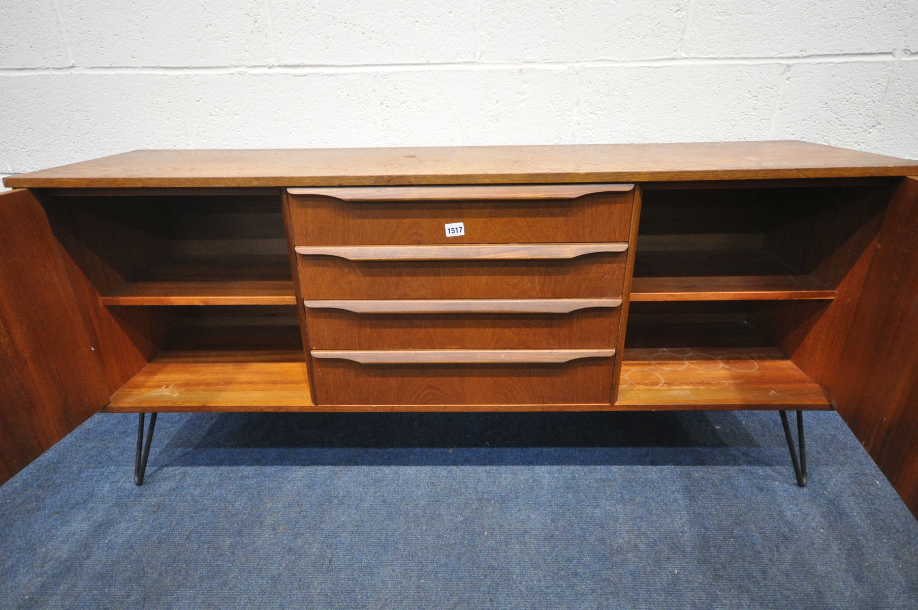A MID CENTURY TEAK SIDEBOARD with two cupboard doors flanking four drawers on later metal hairpin - Image 3 of 3