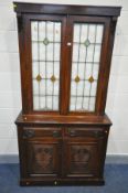 AN EARLY 20TH CENTURY MAHOGANY BOOKCASE, the upper section with double lead glazed/stained glass