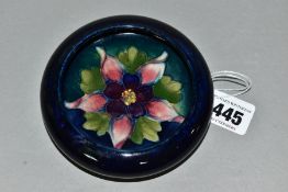 A MOORCROFT POTTERY SMALL CIRCULAR BOWL WITH SCROLL OVER RIM, decorated with a pink / purple