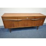 A MID CENTURY TEAK SIDEBOARD, with three frieze drawers, over cupboard doors flanking a fall front