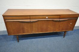A MID CENTURY TEAK SIDEBOARD, with three frieze drawers, over cupboard doors flanking a fall front