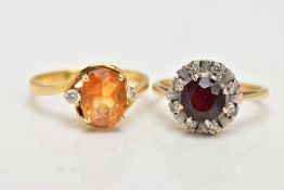 TWO YELLOW METAL GEM SET RINGS, the first of a cluster design, set with a central circular cut