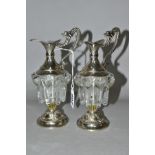 A PAIR OF DECORATIVE GLASS AND EPNS MINIATURE CLARET JUGS, the handles cast as mythical creatures,