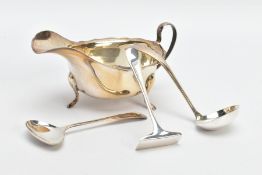 FOUR ITEMS OF SILVER, to include a plain polished gravy boat with wavy rim, raised on three