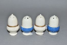 FOUR EARLY 20TH CENTURY MOORCROFT POTTERY ACORN SHAPED PEPPERETTES, two with mottled blue bases