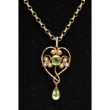 AN EDWARDIAN PERIDOT AND SEED PEARL PENDANT AND A 9CT GOLD CHAIN, the openwork heart shape pendant