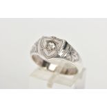 A DIAMOND SIGNET RING, the shield shape panel set with an old cut diamond, tapered shoulders and
