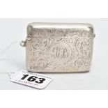 A SILVER VESTA CASE, of a rounded rectangular form, engraved foliate design, centring on an engraved