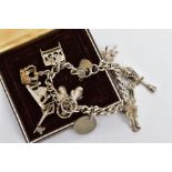 A SILVER CHARM BRACELET, curb link bracelet fitted with fifteen charms in forms such as a street