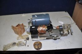 AN UNBRANDED WATCHMAKERS LATHE with aluminium bed, steel slides, a 3 jaw chuck (no key), two sets of