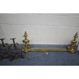 A PAIR OF BRASS ANDIRONS, with adjoining fender, a pair of wrought iron andirons, and a fire