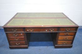 A 20TH CENTURY MAHOGANY PEDESTAL PARTNERS DESK, the double section top with a green gilt tooled