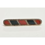 A LATE VICTORIAN SILVER HARDSTONE BROOCH, of an elongated outline inlaid with bloodstone and jasper,