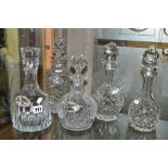 FIVE CUT CRYSTAL DECANTERS, THREE SILVER DECANTER LABELS AND A LARGE FRAMED PICTURE, comprising five