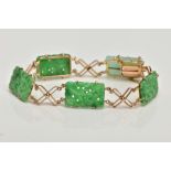 A JADEITE PANEL BRACELET, designed as four rectangular carved jadeite panels and one replacement