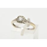A WHITE METAL DIAMOND RING, the ring head of a square design set with a central round brilliant