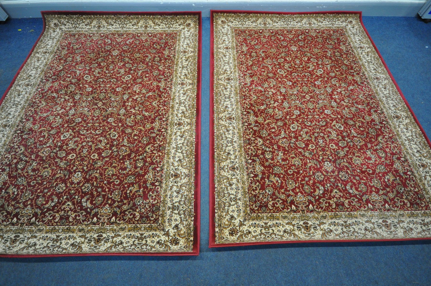 TWO LATE 20TH CENTURY RED AND CREAM ORIENTAL RUGS, made by Dunelm, 230cm x 160cm