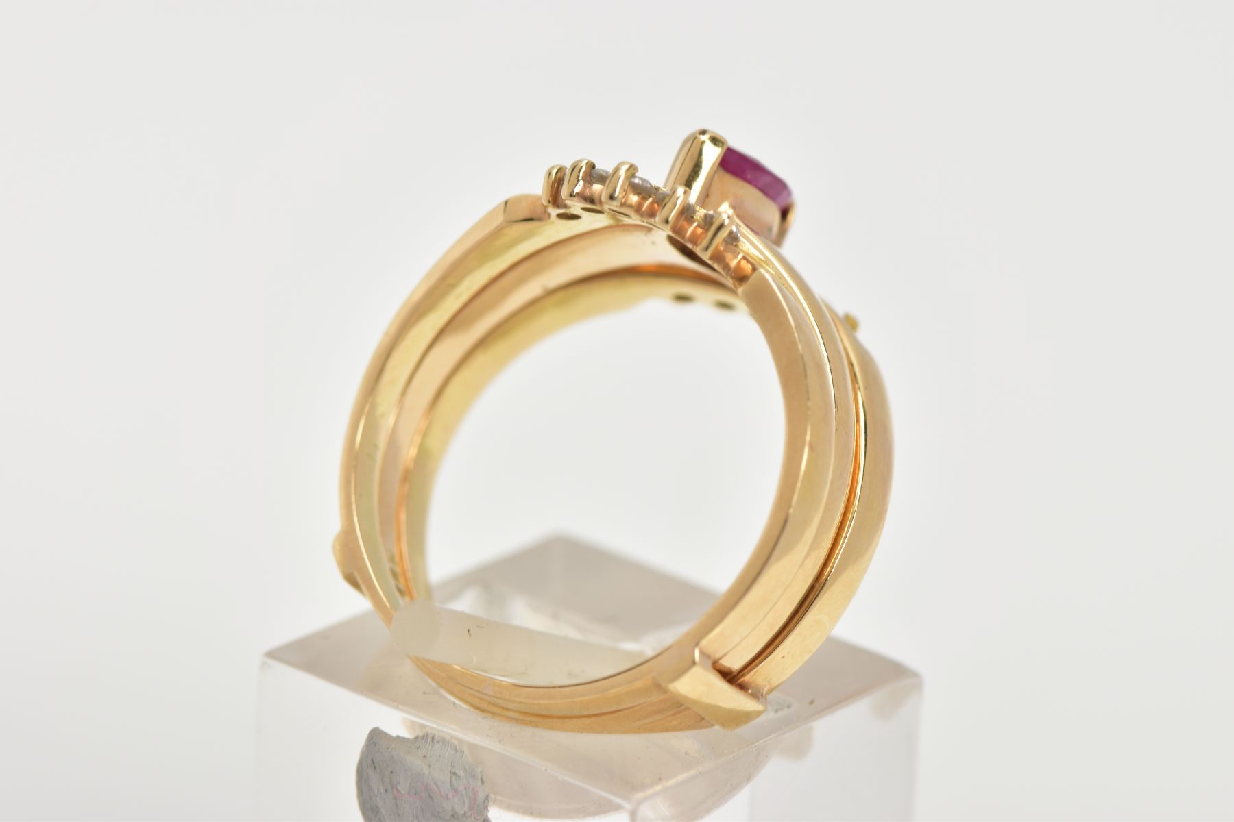 A YELLOW METAL RUBY AND DIAMOND PUZZLE RING, the centre ring designed with a tension set, marquise - Image 3 of 6