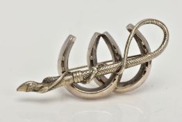 A WHITE METAL BROOCH, designed as two horse shoes, with a crop and hoof, approximate length 54mm,