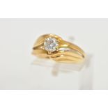 A YELLOW METAL SINGLE STONE DIAMOND RING, designed with a central six claw set, round brilliant