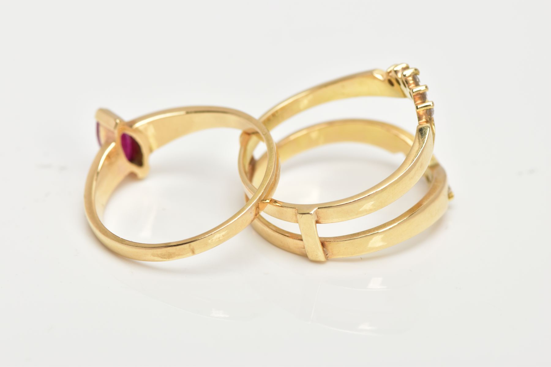A YELLOW METAL RUBY AND DIAMOND PUZZLE RING, the centre ring designed with a tension set, marquise - Image 6 of 6