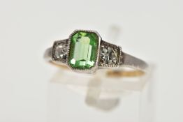 A GREEN PASTE RING, centring on an emerald cut green paste, flanked with two colourless circular cut