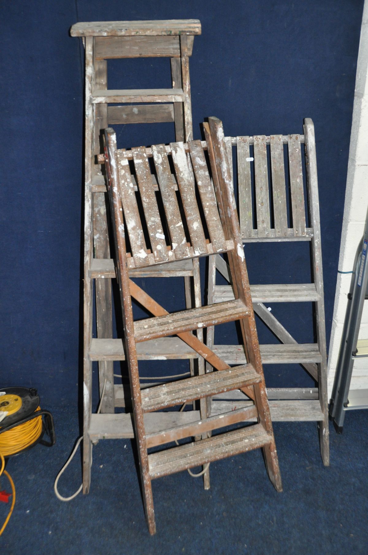 THREE VINTAGE WOODEN STEP LADDERS at 155cm , 135cm and 135cm long