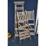 THREE VINTAGE WOODEN STEP LADDERS at 155cm , 135cm and 135cm long