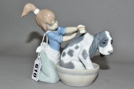 A LLADRO 5445 BASHFUL BATHER SCULPTURE OF A GIRL WASHING A DOG, designed by Juan Huerta in 1988,