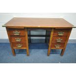 A KNEE HOLE DESK with six drawers and two brushing slides, replacement top and brass corners,