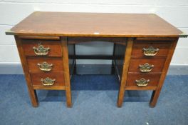 A KNEE HOLE DESK with six drawers and two brushing slides, replacement top and brass corners,