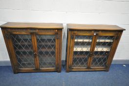 A PAIR OAK TWO DOOR LEAD GLAZED BOOKCASES with three shelves, width 107cm x depth 31cm x height