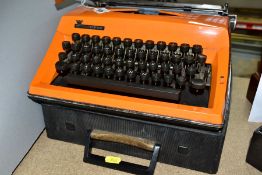 AN ADLER CONTESSA ORANGE TYPEWRITER, 1960s/70s with case, width 30cm, depth 32cm, height 8cm (