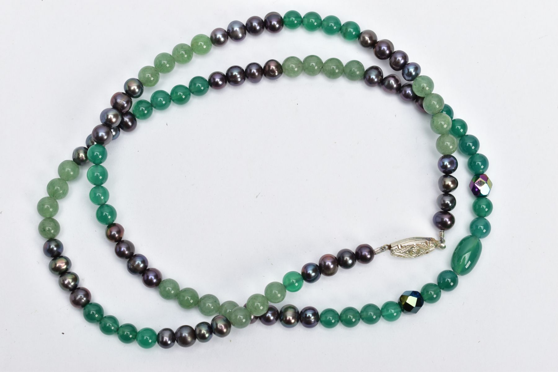 A GEM BEAD NECKLACE, the single row of near uniform mainly spherical beads comprising dyed green