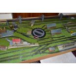 A SUBSTANTIAL OO GAUGE MODEL RAILWAY TRACK LAYOUT, consisting of track, buildings and accessories,