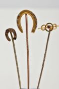 THREE LATE 19TH TO EARLY 20TH CENTURY STICKPINS, to include one horse shoe stickpin with floral