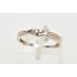 A 9CT WHITE GOLD DIAMOND RING, of a cross over design, centring on three claw set round brilliant