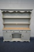 A LARGE PAINTED PINE DRESSER, with three drawers, over double cupboard doors flanking an open