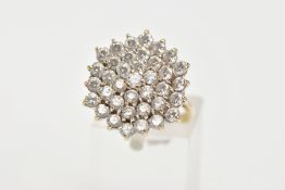 A 9CT GOLD CUBIC ZIRCONIA CLUSTER RING, thirty seven circular cut cubic zirconia within a yellow