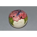 A MOORCROFT POTTERY POMANDER DECORATED WITH A PINK HIBISCUS ON A CREAM GROUND, tube lined date of