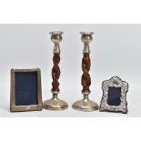 TWO SILVER FRAMES AND A PAIR OF CANDLE STICKS, a silver fronted photo frame, approximate height