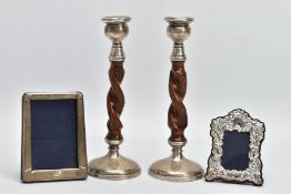 TWO SILVER FRAMES AND A PAIR OF CANDLE STICKS, a silver fronted photo frame, approximate height