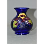 A SMALL MOORCROFT POTTERY COLUMBINE VASE, of globular form, with tubelined purple, yellow and