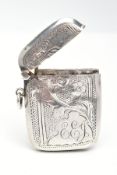 A SILVER VESTA, of a rounded rectangular form, decorated with a floral and foliage design,