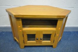 A LIGHT OAK CORNER TV STAND, width 105cm x depth 55cm x height 56cm (condition:- small paint