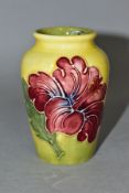 A MOORCROFT POTTERY SMALL BALUSTER VASE DECORATED WITH PINK HIBISCUS, yellow / green ground,